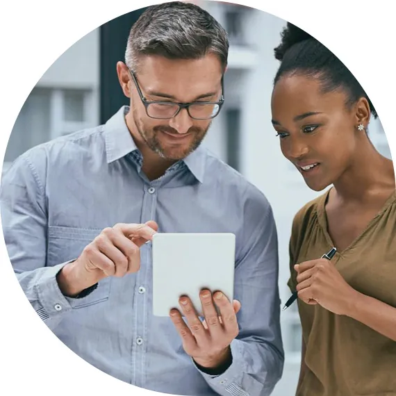 Two colleagues reviewing account numbers on a tablet