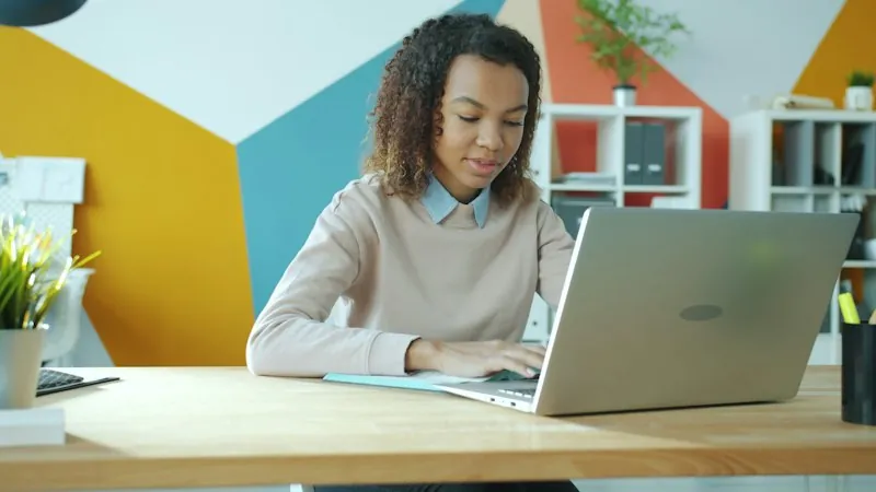 Updating customer records in the CRM on a laptop